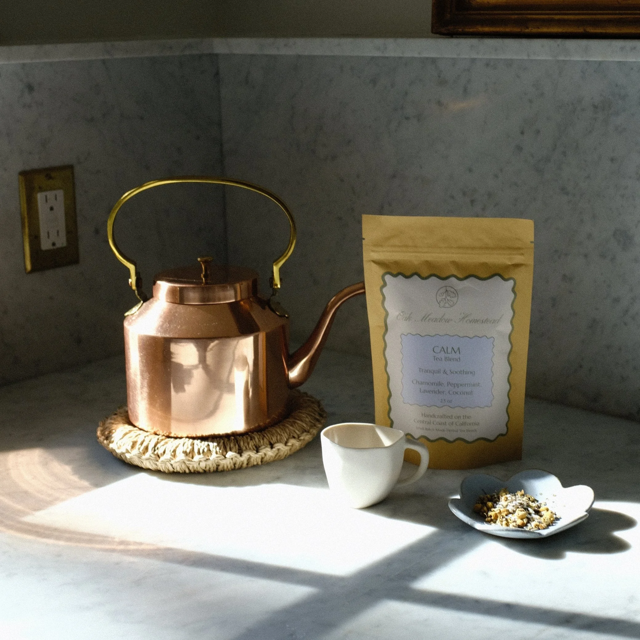 Copper teapot with Oak Meadow Homestead herbal tea blend on marble counter